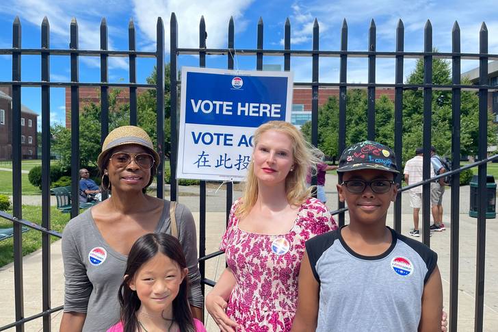 Public school teacher Ella Fredrick, second from right, says she voted early Saturday to get a head start on summer vacation.